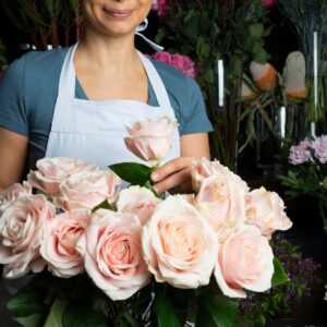 florist arranging pink roses